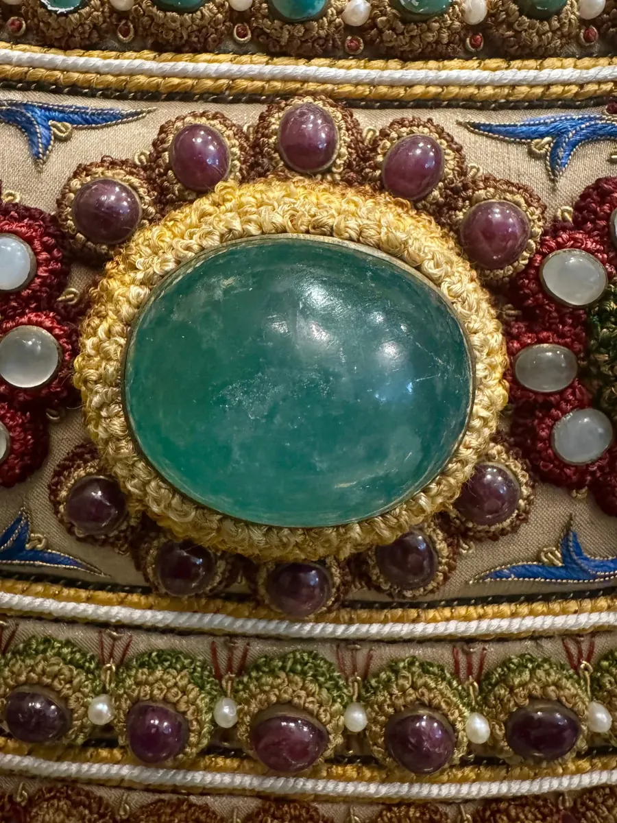Green cabochon in a coiled thread mount